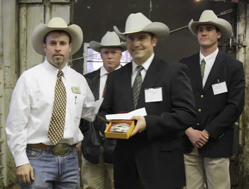 Bob McBride presents the 2009 Livestock Champion buckle to Charly Cummings