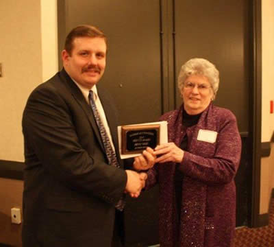 Andy Conser presents the 2010 Service Award to Peggy Giles, Ag Press.