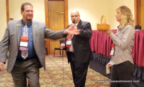 NAA representative Rich Schur rings while Shawn Terrel