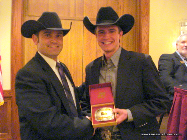 Charly Cummings presents Blaine Lotz with the buckle for the livestock contest